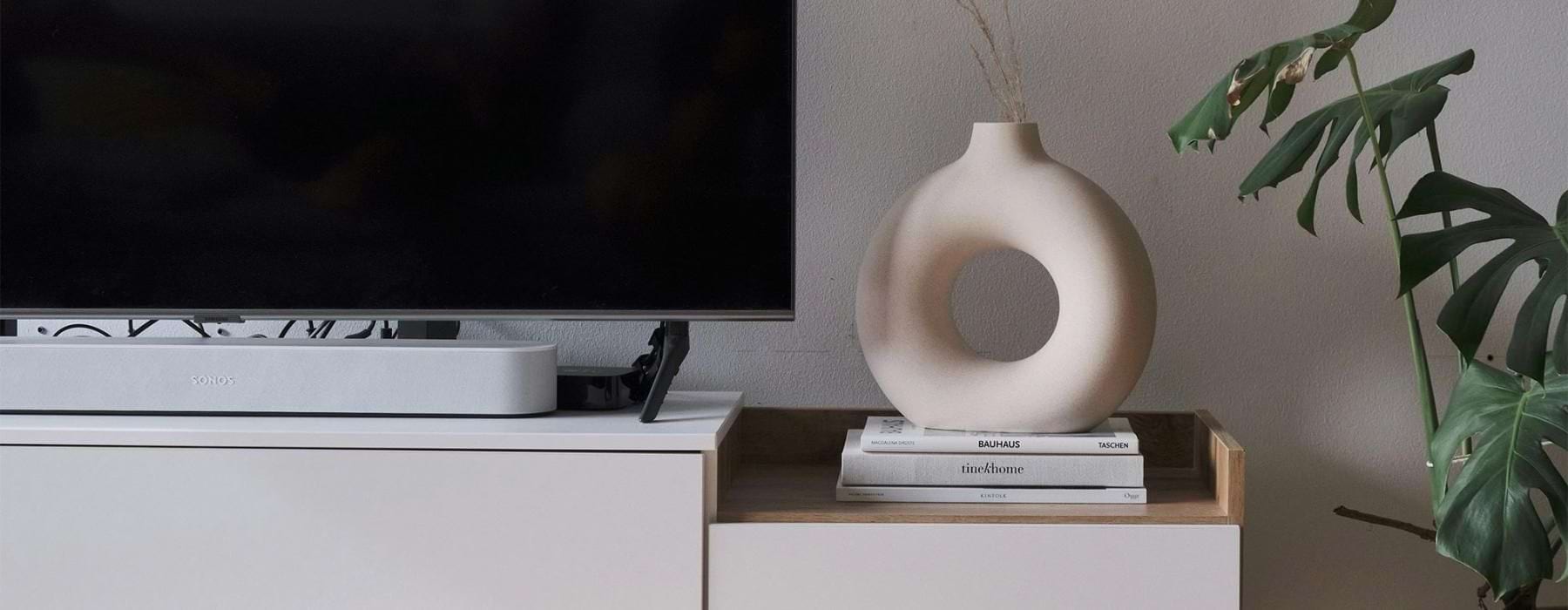 a tv on a stand with decor